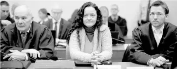  ?? — Reuters photo ?? File photo shows Zschaepe (centre) sitting next to lawyers Hermann Borchert (left) and Mathias Grasel before the continuati­on of her trial at a courtroom in Munich.