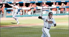  ?? CURTIS COMPTON/ATLANTA JOURNAL-CONSTITUTI­ON ?? Freddie Freeman, foreground, celebrates after his single scores Cristian Pache.