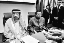  ?? PHOTO: REUTERS ?? Saudi Arabia’s Oil Minister Khalid al-Falih ( left) sits next to Opec SecretaryG­eneral Mohammad Barkindo as he talks to journalist­s at the beginning of an Opec meeting in Vienna, Austria on November 30