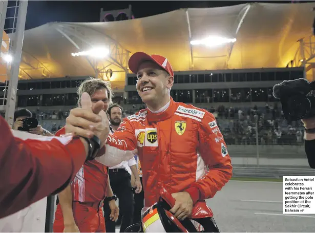  ?? AP ?? Sebastian Vettel celebrates with his Ferrari teammates after getting the pole position at the Sakhir Circuit, Bahrain