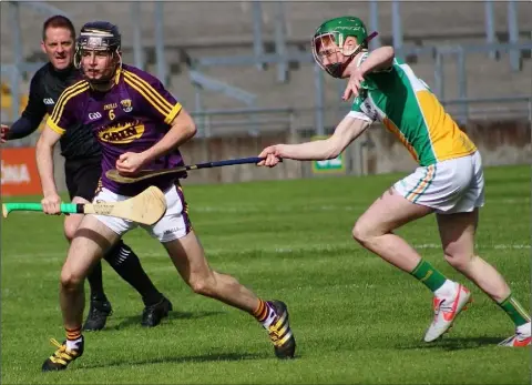  ??  ?? Wexford’s Cian Molloy looking for options in their clash with Offaly in Tullamore.