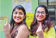  ?? PTI ?? First-time voters show their fingers marked with indelible ink after voting in Bhopal, Madhya Pradesh. Elsewhere in the state, voters defied a Maoist threat to cast their ballots.