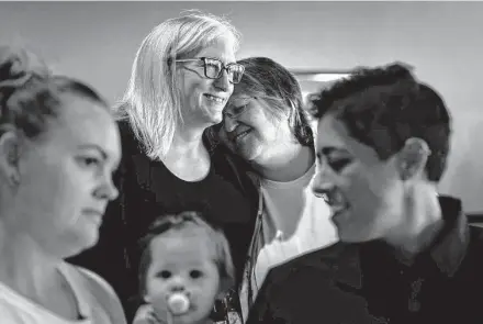  ?? Jon Shapley/Staff photograph­er ?? Molly Lewis-Freeman, center-right, leans her head on her wife of 26 years, Erin, as they listen during a worship service at First Christian Church Katy. The church emphasizes LGBTQ+ inclusivit­y despite the hateful comments it has received.