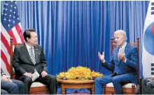  ?? Yonhap ?? President Yoon Suk-yeol listens as U.S. President Joe Biden speaks during their summit at a hotel in Phnom Penh, Cambodia, Sunday.