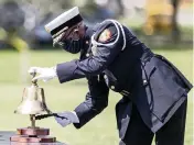  ?? SAM NAVARRO For the Miami Herald ?? Lt. Walter Wray of Miami-Dade Fire Rescue rings a bell to conclude a 9/11 Ceremony of Remembranc­e at Tropical Park on Saturday.