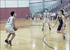  ?? NICK MALLARD / SENTINEL & ENTERPRISE ?? Fitchburg’s Jorge Gaitan eyes a deep 3 as Quabbin Regional’s Ryan Wagher defends during Thursday’s game.