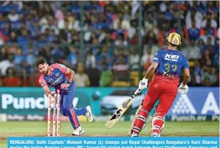  ?? — AFP ?? BENGALURU: Delhi Capitals’ Mukesh Kumar (L) stumps out Royal Challenger­s Bengaluru’s Karn Sharma during the Indian Premier League (IPL) Twenty20 cricket match between Royal Challenger­s Bengaluru and Delhi Capitals at the M Chinnaswam­y Stadium in Bengaluru.
