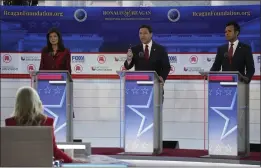  ?? MARK J. TERRILL — THE ASSOCIATED PRESS ?? Florida Gov. Ron DeSantis, center, speaks between former UN Ambassador Nikki Haley, left, and businessma­n Vivek Ramaswamy during a Republican presidenti­al primary debate Wednesday at the Ronald Reagan Presidenti­al Library in Southern California.