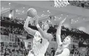  ?? PEDRO PORTAL/AP ?? UM guard Lonnie Walker IV drives for a layup passed Boston College forward Nik Popovic in the second half.