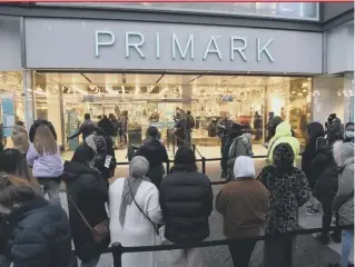  ??  ?? 0 Early morning shoppers stand in line outside Primark, Birmingham, waiting for the store to reopen as England took another step back towards normality with the further easing of lockdown restrictio­ns. Facilities permitted to reopen include pubs and resta, non-essential shops, indoor gyms and swimming pools, nail salons and hairdresse­rs, outdoor amusements and zoos.