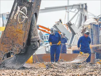  ?? Julia Nikhinson
The Associated Press ?? Workers use torches to break apart salvaged pieces of the collapsed Francis Scott Key Bridge on Friday at Tradepoint Atlantic in Sparrows Point, Md.