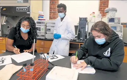  ?? Julia malakie / lowell sun ?? students Danisha Ramirez of lowell, left, and samantha martinez of methuen, with t.a. Ashraf nuguluma, work on a biology experiment at the middlesex Community College campus in downtown lowell last week.