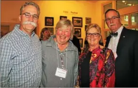  ??  ?? Deddy Odom of Tellico Village, Tenn., and his artistic wife, Kathie, get a nod of approval from event co-chair Lindsay DuBarry of Villanova and her husband, Joe.