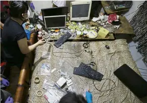  ?? — Photos: ap ?? a file photo of National Bureau of investigat­ion and FBI members gathering evidence at the home of a suspected child webcam cybersex operator during a raid in the Philippine­s.