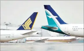  ?? THE STRAITS TIMES ?? Singapore Airlines (left) and a SilkAir plane parked at Changi Airport.