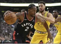  ??  ?? The Raptors’ Kawhi Leonard, left, drives past the Warriors’ Klay Thompson on Thursday. The former Spurs star scored 37 points.