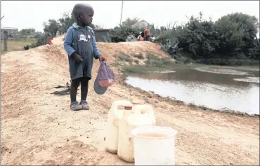  ?? PHOTO: EPA ?? Thandeka Ranthebo stands next to a nearly empty pond in a village in the Makhoarane District of Maseru, Lesotho, in this file photo. The impact of climate change is likely to be more severe in Africa than in other regions of the world.