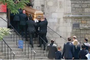  ?? The Associated Press ?? Q The family of Ivana Trump follows behind as pallbearer­s carry her casket Wednesday into St. Vincent Ferrer Roman Catholic Church in New York. Ivana Trump, an icon of 1980s style, wealth and excess and a businesswo­man who helped her husband build an empire, is set to be celebrated at a funeral Mass at St. Vincent Ferrer Roman Catholic Church following her death last week.