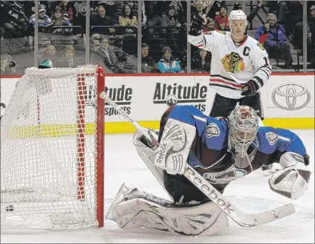  ??  ?? Blackhawks center Jonathan Toews watches as a shot slips past Avalanche goalie Semyon Varlamov Monday.
| JACK DEMPSEY~AP