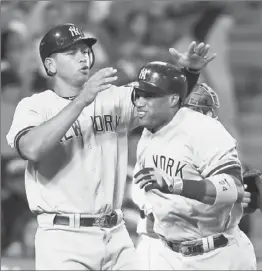  ?? Jeff Gross Getty Images ?? THE YANKEES’ Robinson Cano is greeted by Alex Rodriguez after his two-run homer capped a five-run outburst against Ervin Santana in the third inning.