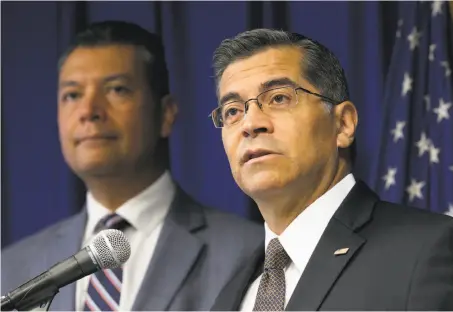  ?? Rich Pedroncell­i / Associated Press ?? California Attorney General Xavier Becerra (right), with Secretary of State Alex Padilla, announces that California will sue the federal government to protect immigrants who had signed on to the Deferred Action for Childhood Arrivals program.