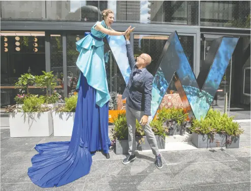  ?? PETER J. THOMPSON / NATIONAL POST ?? W Toronto Hotel GM Craig Reaume high-fives stilt performer Sequoia Erickson this week at its unveiling at 90 Bloor Street East. It is not necessaril­y in Yorkville, but the popular district’s boundaries are expanding.
