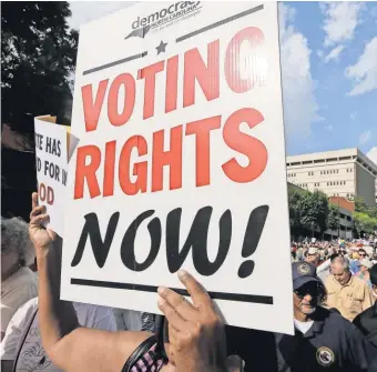  ?? CHUCK BURTON, AP ?? Voting rights activists march through the streets of Winston- Salem, N. C.