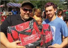  ?? PAUL POST — PPOST@DIGITALFIR­STMEDIA.COM ?? Chad Vergine, left, and Jeremy Stewart, right, of Schenectad­y, picked up cooler bags for relatives and friends Monday at Saratoga Race Course.