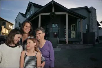  ?? ?? Heather Szucs, top, and daughters Savanah, 11, left, and Zoe, 8, front right, and Heather’s mother, Joan Wharton, prepare for Christmas in their new home.