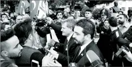  ??  ?? Rebirth Party leader Erhan Arıklı and MP Bertan Zaroğlu with angry protestors who later turned their attention to Parliament. Right, Grey Wolf head Fetih Ancı making a public statement.