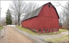  ??  ?? A barn on Sanford Road in Southbury on Friday. Below, cars exit the Southbury Plaza.