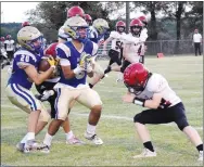  ?? Westside Eagle Observer/MIKE ECKELS ?? Bulldog Robert Thang blocks out a Rattler defender behind him as he prepares to take out the defender in front, allowing running back Kenneth Barrios a little running room during the first quarter of the DecaturMag­azine homecoming football contest in Decatur Friday night.