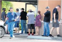  ?? JOE BURBANK/ORLANDO SENTINEL ?? Shoppers wait outside Shoot Straight in Casselberr­y on Sunday. Gun sales have increased across the state during the pandemic.