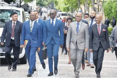  ?? Picture: GCIS ?? FINANCE TEAM. Malusi Gigaba flanked by deputy minister Sfiso Buthelezi and SA Revenue Service commission­er Tom Moyane en route to deliver his mid-term budget policy statement yesterday.