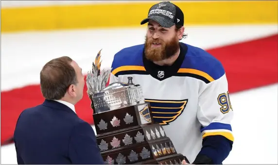  ?? CHRISTOPHE­R EVANS — BOSTON HERALD ?? Ryan O’Reilly of the St. Louis Blues is awarded the Conn Smythe Trophy after winning the Stanley Cup final at TD Garden in Boston on June 12, 2019.