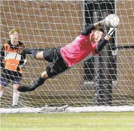  ?? DAVID GARRETT/SPECIAL TO THE MORNING CALL ?? Liberty goalkeeper Blake Koski makes a diving save during Tuesday night’s game against rival Freedom.