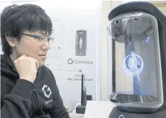  ?? BLOOMBERG ?? Minori Takechi, CEO of Vinclu Inc, interacts with Hikari Azuma, the first character for the Gatebox virtual home robot during a demonstrat­ion at the company’s office in Tokyo.