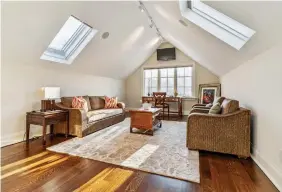  ?? SOTHEBY'S REALTY CANADA PHOTOS ?? The third-floor loft is a favourite space, with skylights drawing in sunshine to illuminate warm hardwood and sloped ceilings.