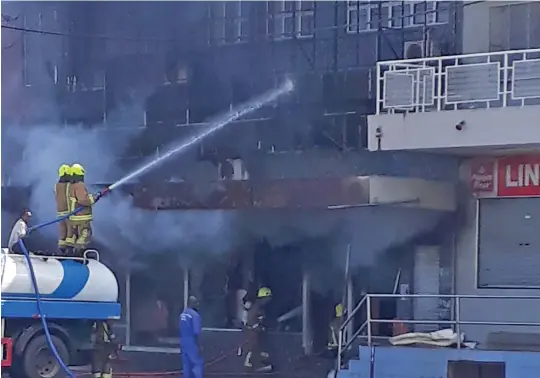  ?? Photo: Ilaisa Vakaloloma ?? Firefighte­rs from the National Fire Authority work to contain the fire at the A.Gafoor building in Rakiraki town on May 25, 2020.