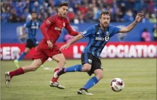  ?? PAUL CHIASSON, THE CANADIAN PRESS ?? Toronto FC midfielder Jonathan Osorio and Montreal Impact forward Harrison Shipp battle for the ball during the first half of the Amway Canadian Championsh­ip semifinal last June in Montreal.
