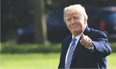  ?? THE ASSOCIATED PRESS ?? President Donald Trump walks across the South Lawn of the White House in Washington on Friday as he heads to Marine One. Trump is heading to Florida, where he will spend the weekend at the Mar-a-Lago estate.