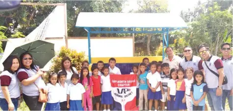  ??  ?? Members of UAP North Davao pose with school teachers and pupils during the turnover of the project.