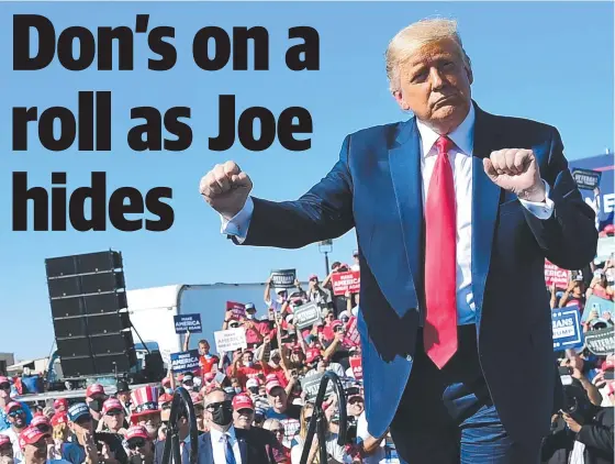  ??  ?? A buoyant Donald Trump salutes his supporters during a rally at Prescott Regional Airport in the crucial swing state of Arizona. Picture: AFP