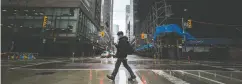  ?? PETER J THOMPSON FOR NATIONAL POST ?? A pedestrian wearing a mask walks across Toronto’s Yonge Street amid the ongoing coronaviru­s crisis.