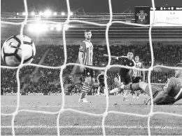  ??  ?? Arsenal’s Alexis Sanchez scores the first goal during the English Premier League match against Southampto­n at St Mary’s Stadium. — Reuters photo