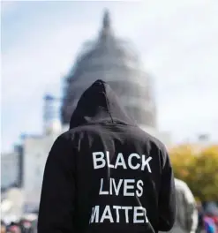  ??  ?? WASHINGTON: In this Oct 10, 2015 file photo, a man wears a hoodie which reads, “Black Lives Matter” as he stands on the lawn of the Capitol building on Capitol Hill. —AP