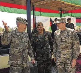  ?? LOLITA BALDOR / ASSOCIATED PRESS ?? Gen. John Nicholson (from left), the top U.S. commander in Afghanista­n, talks with Col. Khanullah Shuja, commander of the national mission brigade of the Afghan special operations force, and Gen. Joseph Votel, head of U.S. Central Command, at Camp...