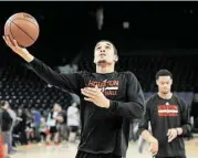  ??  ?? Seldom seeing the court during the Rockets’ postseason run, guard Nick Johnson finds practice shootaroun­ds the only time he can stay sharp.