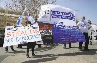  ?? Emmanuel Dunand / AFP / Getty Images ?? Supporters of Israeli Prime Minister Benajamin Netanyahu and the Likud party protest outside parliament in Jerusalem. Likud members are urging defiance of some Supreme Court orders.