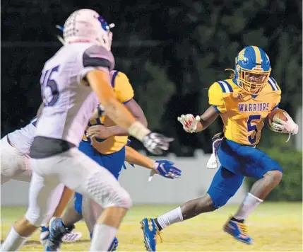  ?? MICHAELA BARNEY/FOR THE ORLANDO SENTINEL ?? Orlando Christian Prep running back Brian Thomas (5), pictured as a freshman last fall against Mount Dora Christian Academy, leads the Warriors into their season opener Friday at Orangewood Christian.